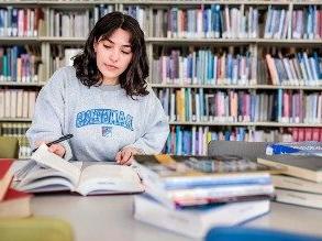 Abrianna Mangiamele, a third-year MSU Denver student majoring in Public Relations, works as a student intern for the OER task force and is seen here studying at the library.